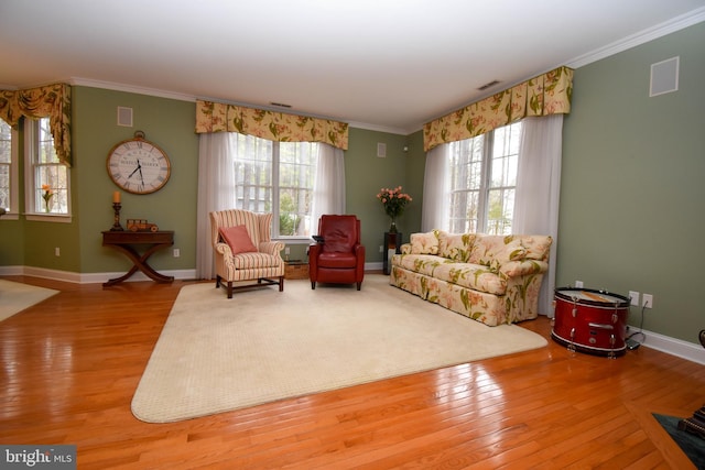 living area featuring crown molding and wood-type flooring