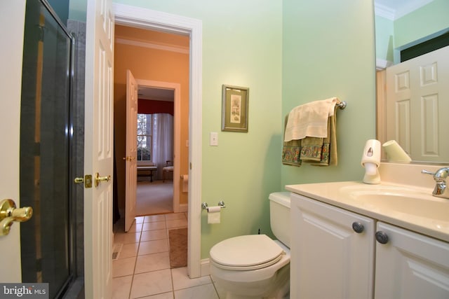 bathroom featuring tile patterned flooring, toilet, vanity, and ornamental molding