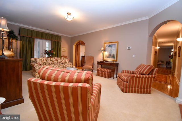 carpeted bedroom featuring crown molding and arched walkways