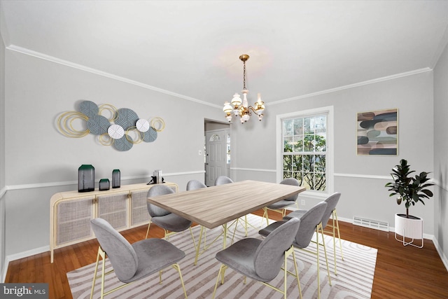 dining space featuring visible vents, baseboards, an inviting chandelier, and wood finished floors