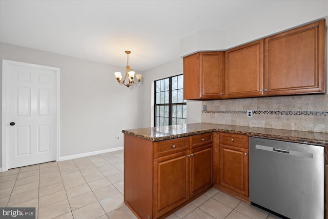 kitchen featuring brown cabinets, dishwasher, a peninsula, and an inviting chandelier