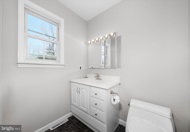 bathroom with vanity, baseboards, visible vents, toilet, and marble finish floor