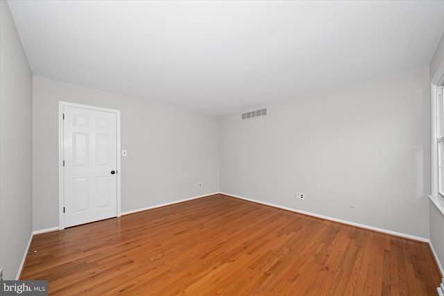 unfurnished room featuring baseboards, visible vents, and light wood-type flooring