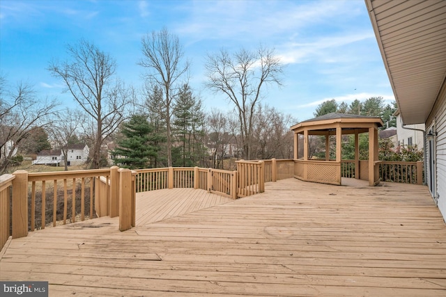 wooden terrace featuring a gazebo