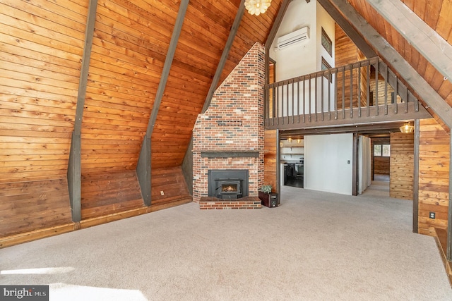 unfurnished living room featuring lofted ceiling with beams, an AC wall unit, wood ceiling, wood walls, and carpet flooring