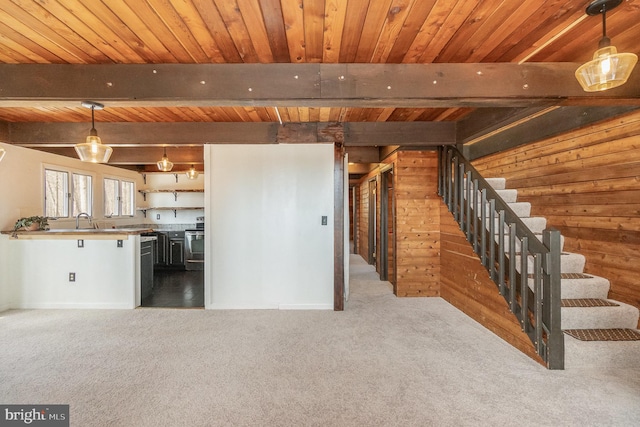 below grade area featuring stairs, wooden ceiling, carpet flooring, and wood walls