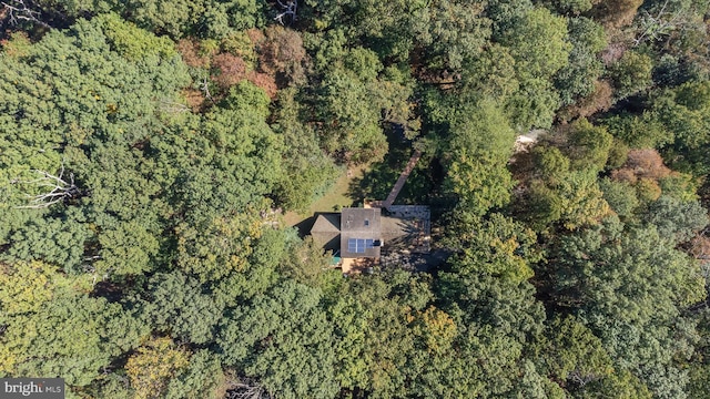 drone / aerial view with a wooded view