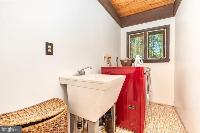 laundry area featuring laundry area, washer and dryer, wood ceiling, and a sink