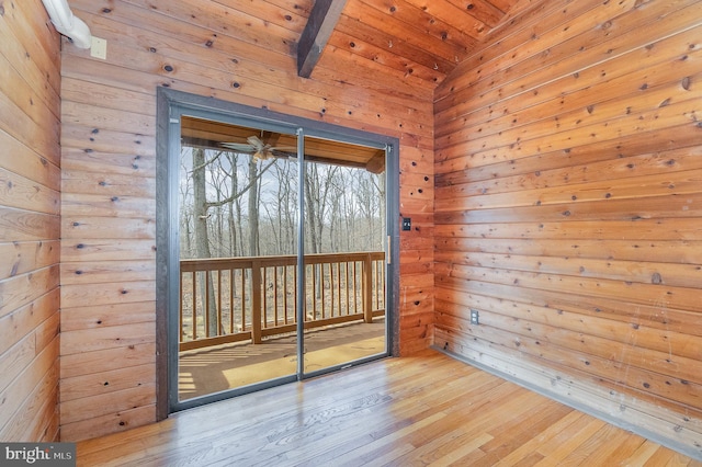 empty room with lofted ceiling, wood ceiling, and hardwood / wood-style floors