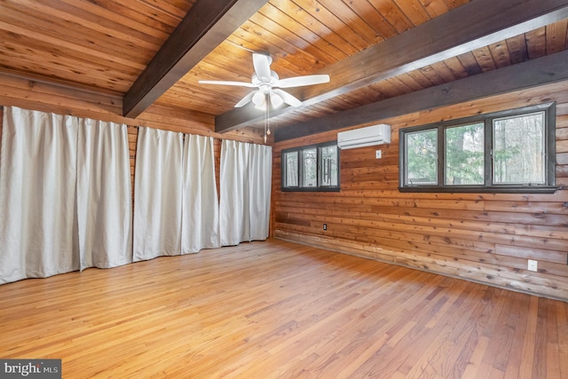 spare room with beamed ceiling, wooden ceiling, a wall mounted air conditioner, and hardwood / wood-style floors