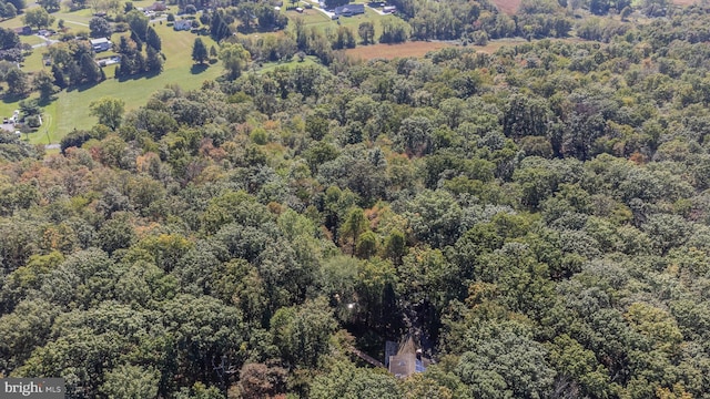 birds eye view of property with a forest view