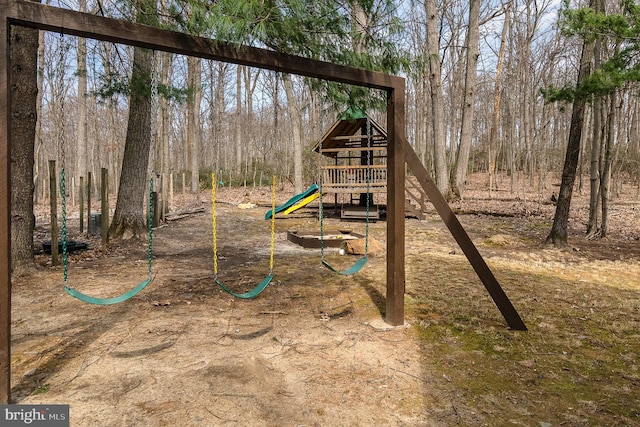 view of play area with a forest view