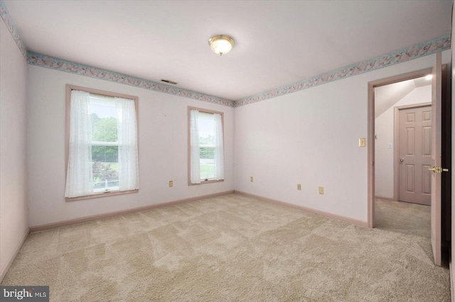 spare room featuring visible vents, baseboards, and carpet