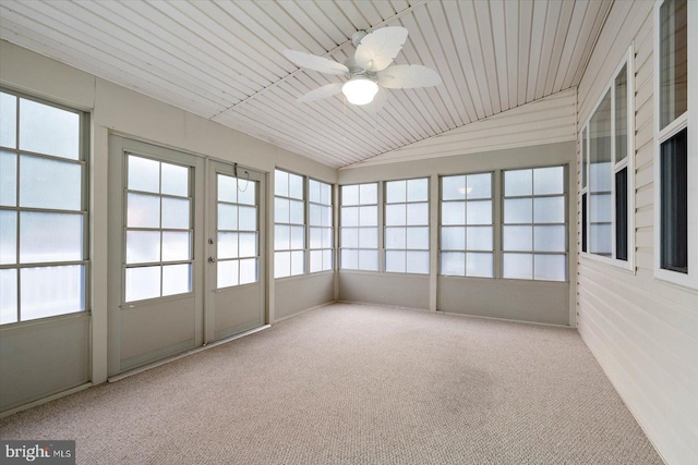 unfurnished sunroom featuring plenty of natural light, a ceiling fan, and lofted ceiling