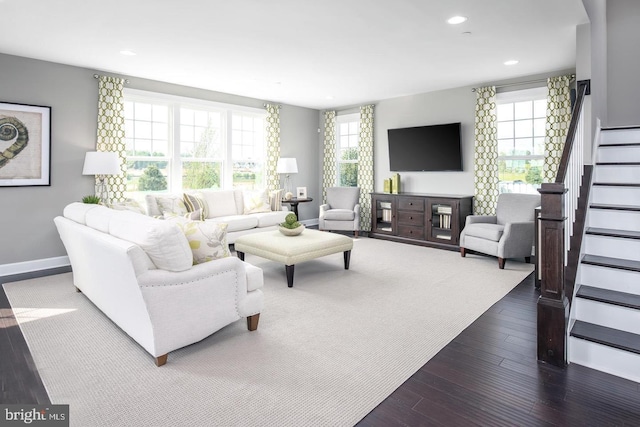 living room with recessed lighting, baseboards, dark wood-type flooring, and stairs