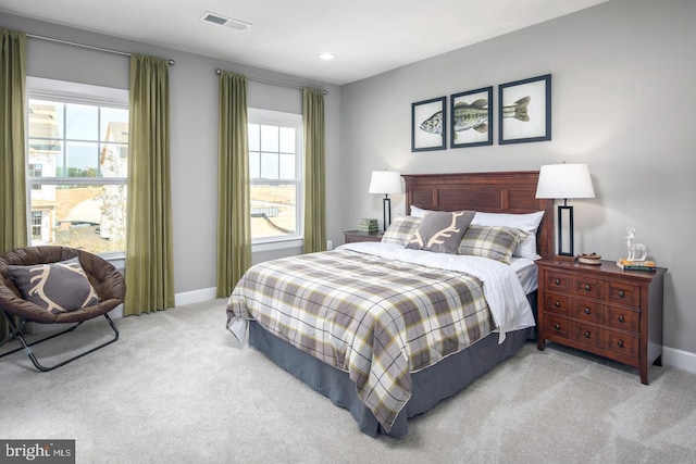 carpeted bedroom with baseboards and visible vents