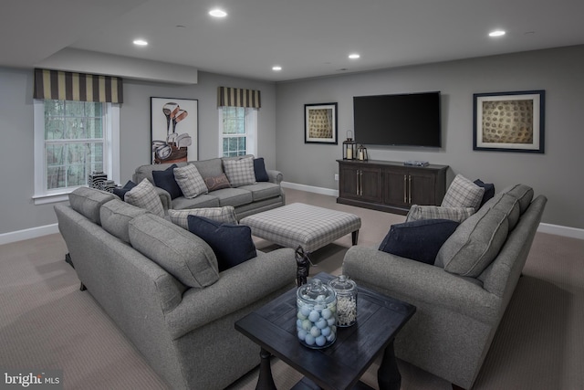 living area with light carpet, recessed lighting, and baseboards