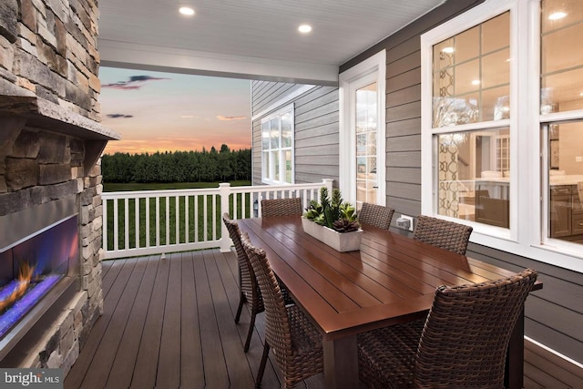 deck at dusk featuring a porch