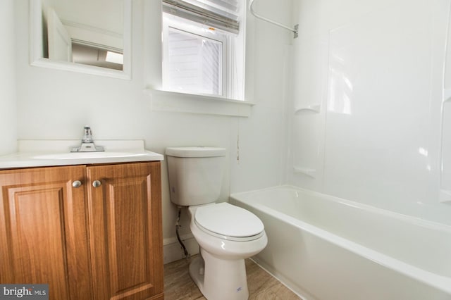 full bath with vanity, shower / tub combination, toilet, and wood finished floors