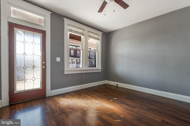 entryway with baseboards, wood finished floors, and a ceiling fan