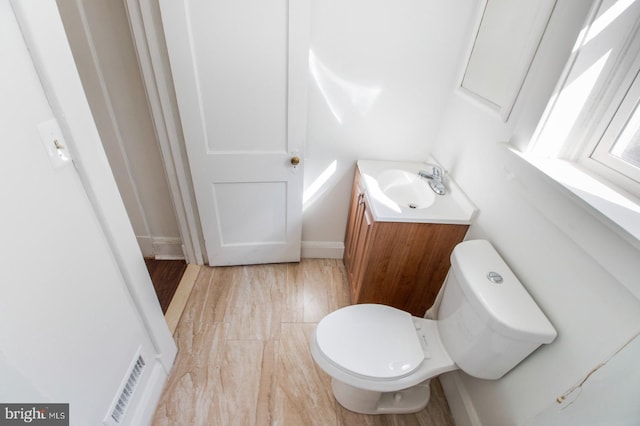 half bathroom featuring toilet and vanity