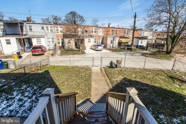 view of yard with a fenced front yard and a residential view