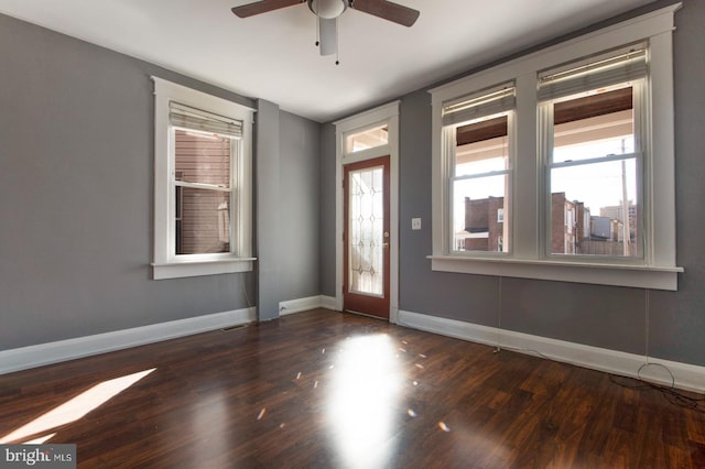 foyer entrance with plenty of natural light, wood finished floors, baseboards, and ceiling fan