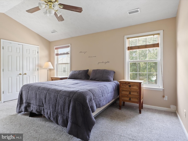 bedroom with baseboards, visible vents, carpet, and vaulted ceiling
