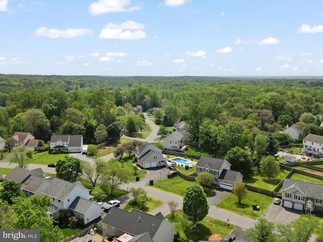 drone / aerial view with a residential view and a wooded view