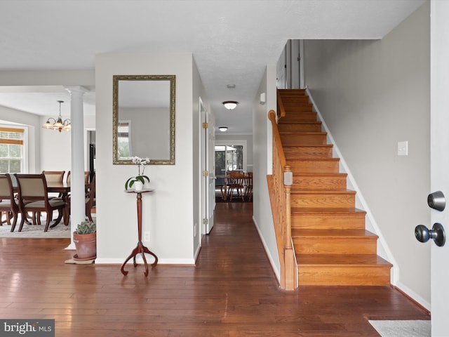 entryway featuring hardwood / wood-style floors, a wealth of natural light, and stairs
