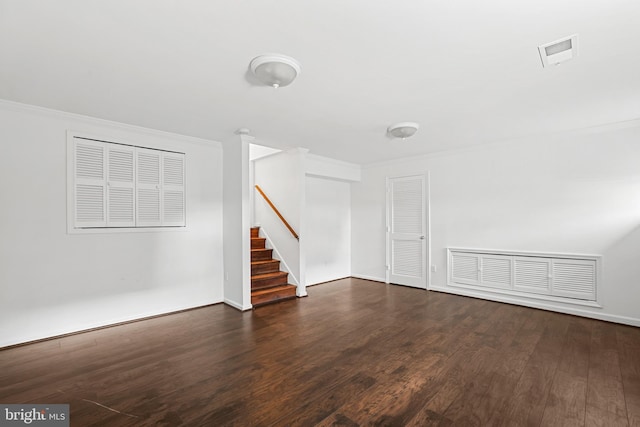 below grade area featuring visible vents, stairway, crown molding, and wood finished floors