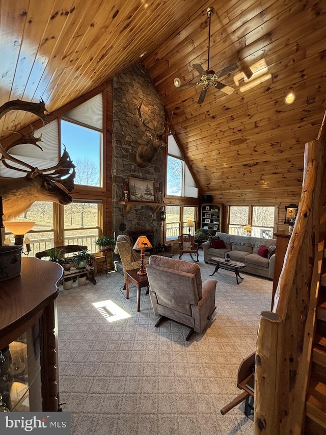 carpeted living area featuring ceiling fan, wood ceiling, a wealth of natural light, and high vaulted ceiling