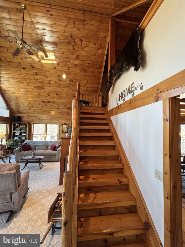 stairway with lofted ceiling, carpet, wooden ceiling, and ceiling fan