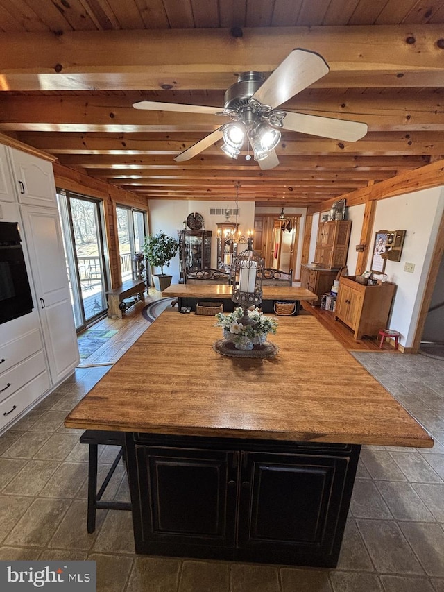 dining space with beam ceiling, ceiling fan, and wooden ceiling