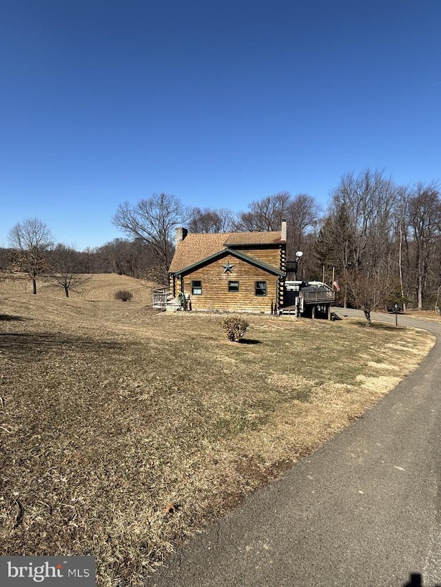 view of property exterior with a chimney