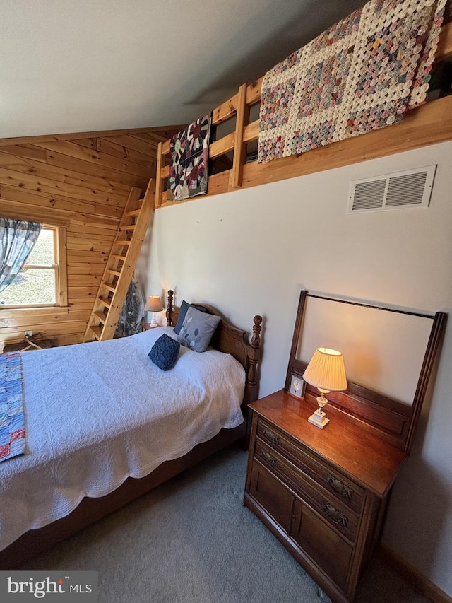 carpeted bedroom featuring vaulted ceiling, visible vents, and wood walls