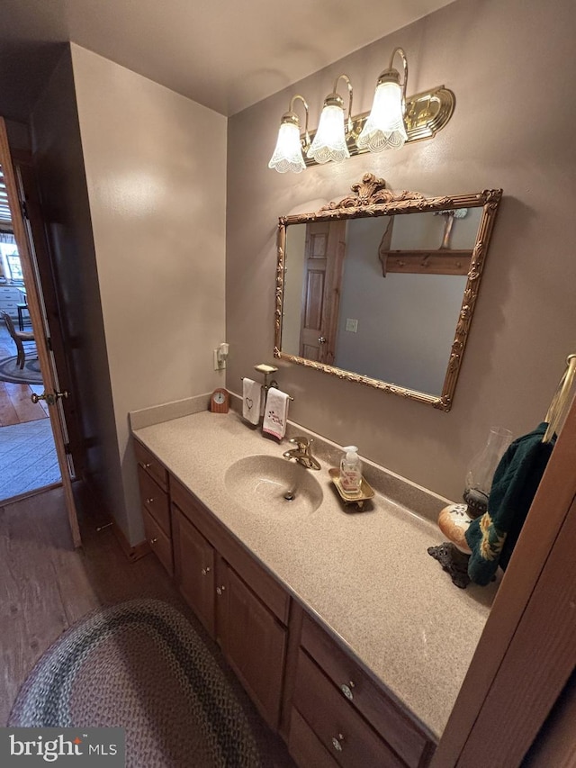 bathroom with vanity and wood finished floors