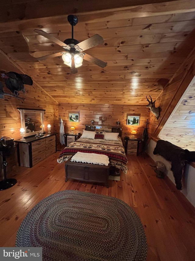 bedroom featuring wood ceiling, hardwood / wood-style floors, and wood walls