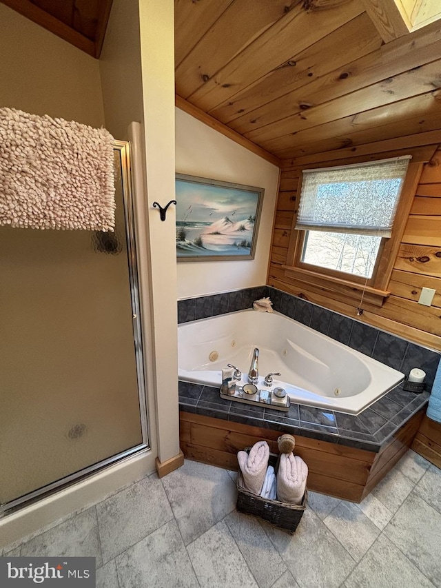 full bath with a jetted tub, lofted ceiling with skylight, stone tile floors, wooden ceiling, and a stall shower