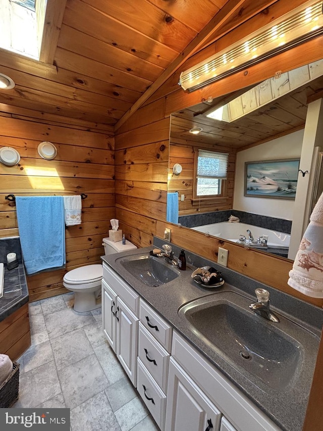 full bathroom featuring a sink, lofted ceiling with skylight, and wood ceiling