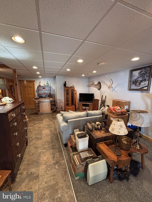 living room featuring recessed lighting and a paneled ceiling