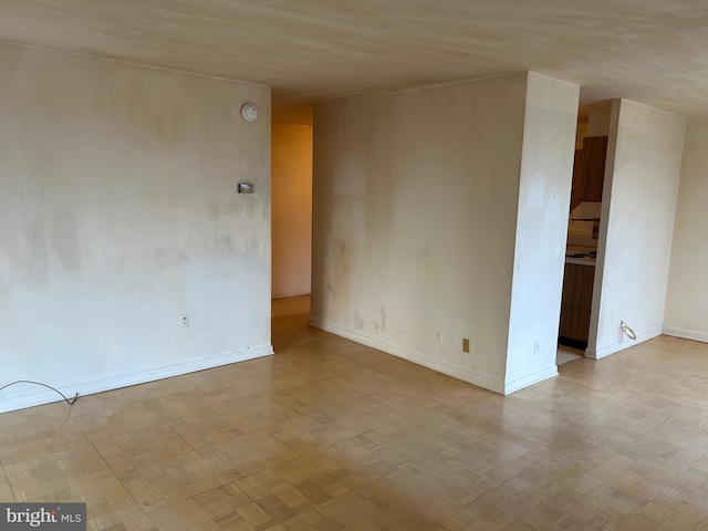 spare room featuring baseboards