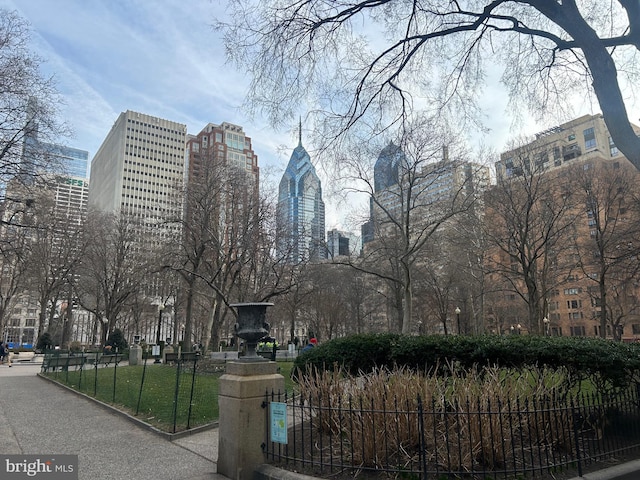 view of property's community featuring a city view and fence