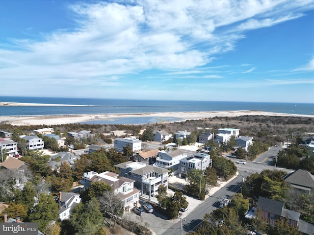 birds eye view of property featuring a water view and a beach view