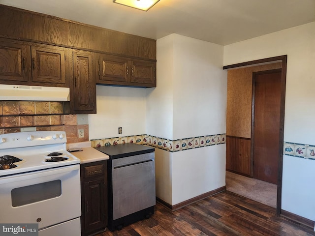 kitchen with electric range, a wainscoted wall, under cabinet range hood, dark wood-style floors, and light countertops