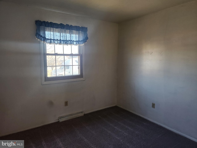 spare room featuring a baseboard radiator, baseboards, and dark colored carpet