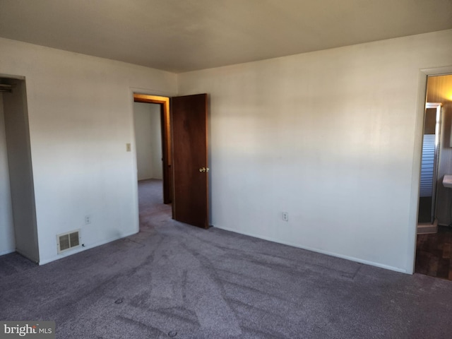 unfurnished bedroom with visible vents and carpet