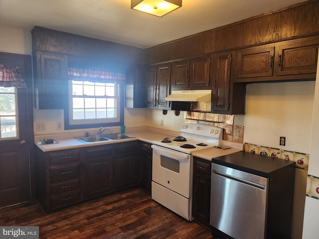 kitchen featuring under cabinet range hood, a sink, a wealth of natural light, and white electric range oven