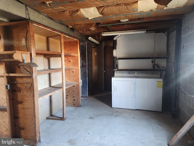 unfinished below grade area featuring washer and dryer and concrete block wall