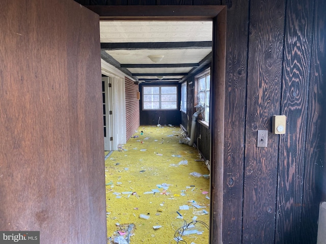 hallway featuring beam ceiling